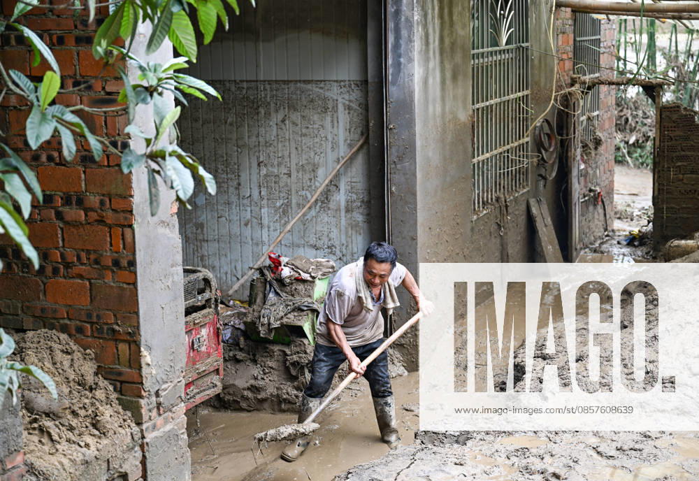 (260526) -- CHONGQING, May 26, 2026 -- A villager cleans up silt-covered livestock enclosure at Daqiao Village of Yongchuan District, southwest China s Chongqing Municipality, May 26, 2026. From Saturday night to early Sunday morning, a sudden and extreme catastrophic rainstorm struck Yongchuan, triggering flash floods and geological disasters in multiple areas of this district. After the disaster occurred, the local authorities immediately activated the emergency response mechanism, coordinated rescue forces from all sides and made every effort to carry out rescue operations and infrastructure restoration. Rescue and response efforts are still underway. ) CHINA-CHONGQING-FLOOD-RESCUE (CN) WangxQuanchao