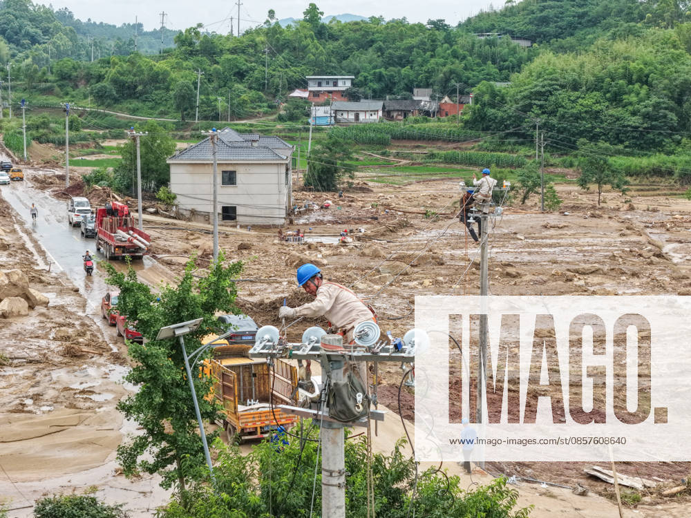 (260526) -- CHONGQING, May 26, 2026 -- A drone photo taken on May 26, 2026 shows staff members of State Grid Chongqing Yongchuan Power Supply Company repairing power supply lines at Anxi Village of Yongchuan District, southwest China s Chongqing Municipality, May 26, 2026. From Saturday night to early Sunday morning, a sudden and extreme catastrophic rainstorm struck Yongchuan, triggering flash floods and geological disasters in multiple areas of this district. After the disaster occurred, the local authorities immediately activated the emergency response mechanism, coordinated rescue forces from all sides and made every effort to carry out rescue operations and infrastructure restoration. Rescue and response efforts are still under