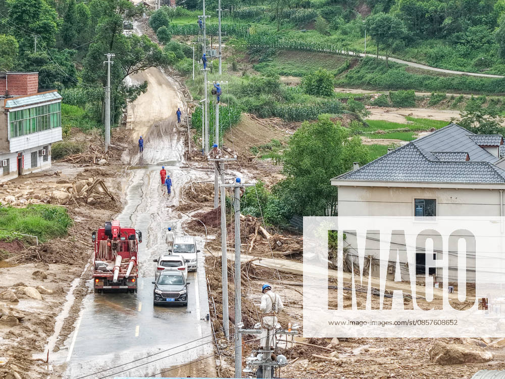 (260526) -- CHONGQING, May 26, 2026 -- A drone photo taken on May 26, 2026 shows staff members of State Grid Chongqing Yongchuan Power Supply Company repairing power supply lines at Anxi Village of Yongchuan District, southwest China s Chongqing Municipality, May 26, 2026. From Saturday night to early Sunday morning, a sudden and extreme catastrophic rainstorm struck Yongchuan, triggering flash floods and geological disasters in multiple areas of this district. After the disaster occurred, the local authorities immediately activated the emergency response mechanism, coordinated rescue forces from all sides and made every effort to carry out rescue operations and infrastructure restoration. Rescue and response efforts are still under