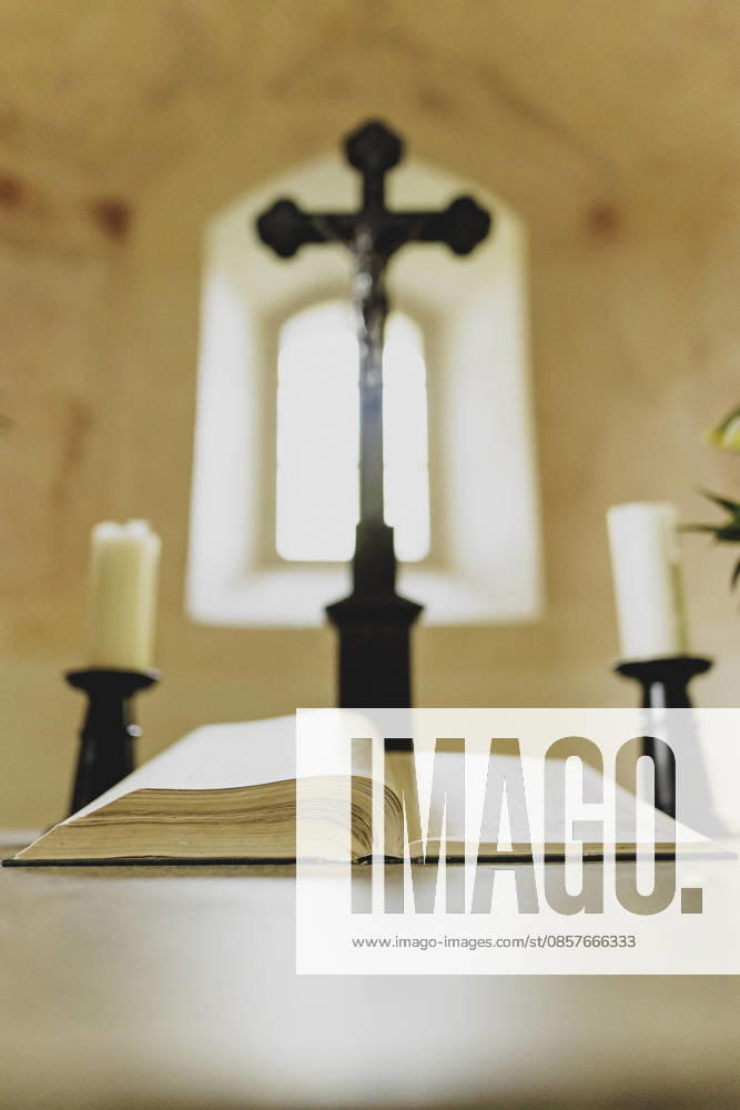 A cross and the open Bible on the altar in the Protestant church in Arnsdorf, 23 05 2026 Arnsdorf Germany