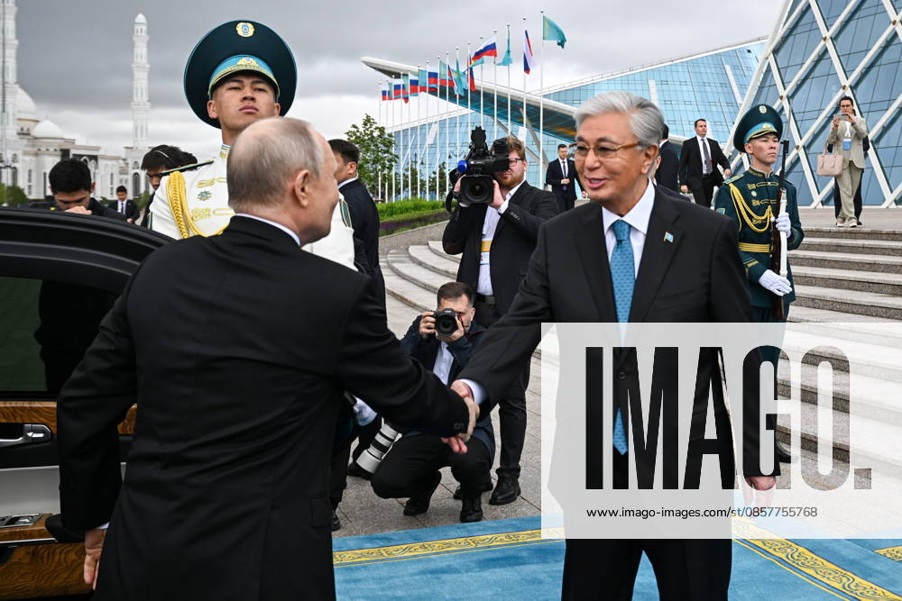 KAZAKHSTAN, ASTANA - MAY 28, 2026: Russia s President Vladimir Putin and Kazakhstan s President Kassym-Jomart Tokayev (L-R front) shake hands during a welcome ceremony outside the Independence Palace. Sergei Bobylev TASS 93123011