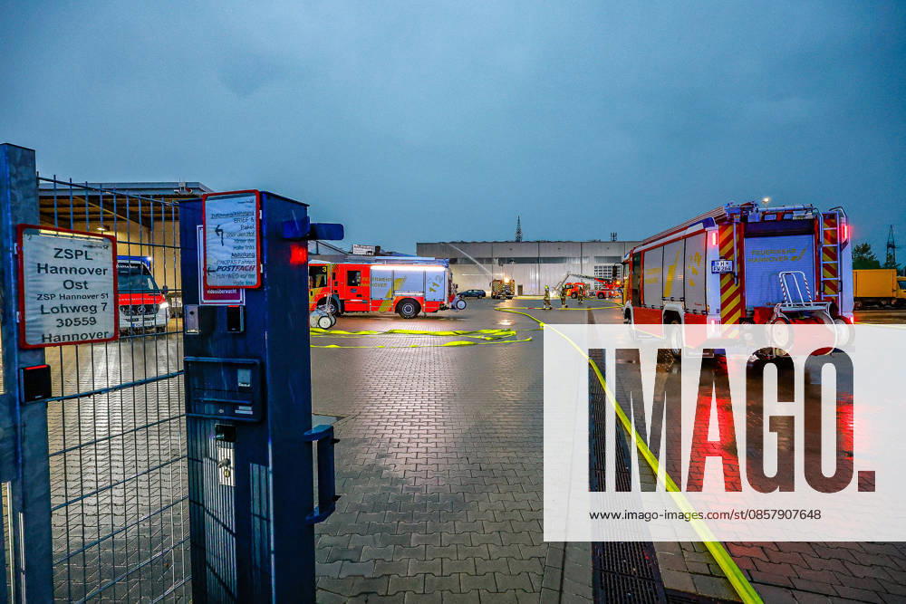 Major fire in a warehouse and logistics hall Main entrance to the warehouse, fire engines and turntable ladder of the Hanover fire department in the background Hanover Anderten Lohweg 7, Lower Saxony industrial estate, Hanover region Germany