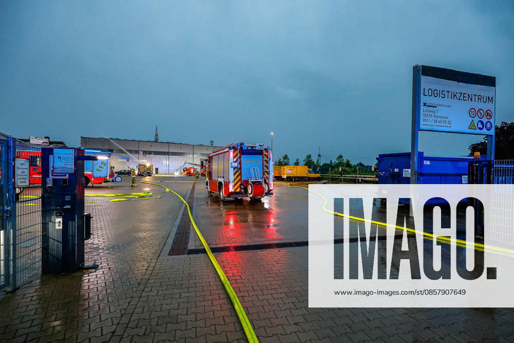 Major fire in a warehouse and logistics hall Main entrance to the warehouse, fire engines and turntable ladder of the Hanover fire department in the background Hanover Anderten Lohweg 7, Lower Saxony industrial estate, Hanover region Germany