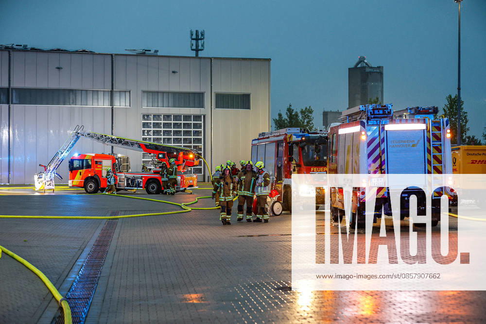 Major fire in a warehouse and logistics hall Main entrance to the warehouse, fire engines and turntable ladder of the Hanover fire department in the background Hanover Anderten Lohweg 7, Lower Saxony industrial estate, Hanover region Germany