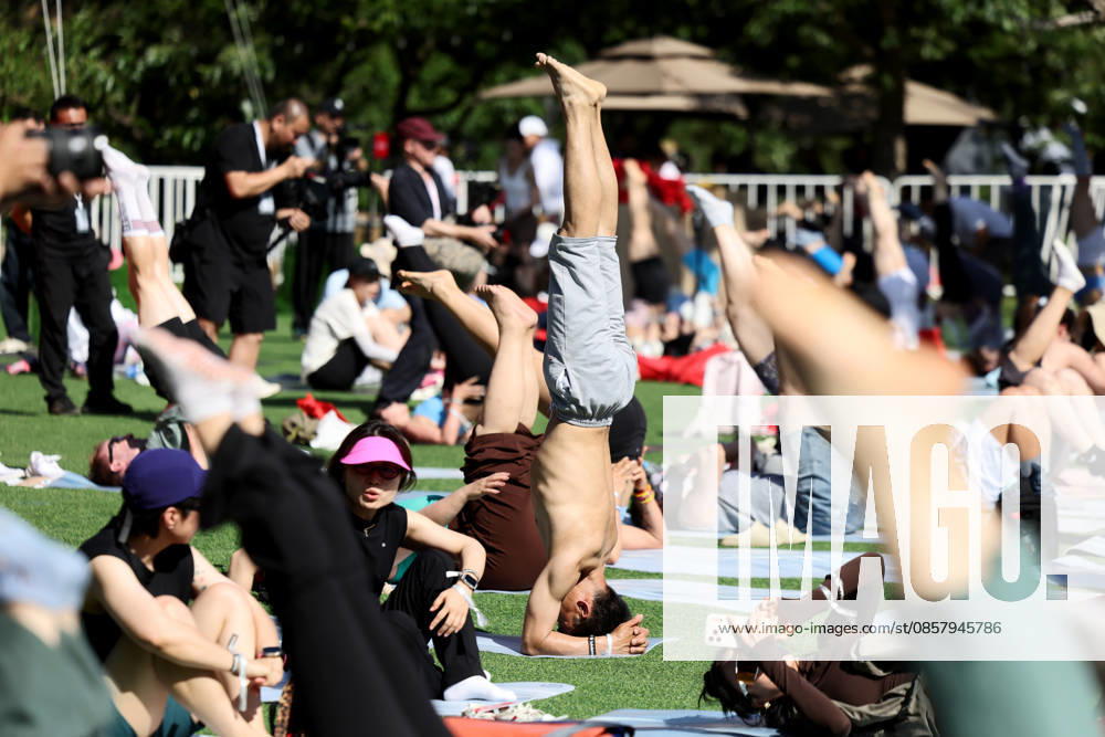 Yoga enthusiasts practice yoga at the foot of Huanghuacheng Lakeside Great Wall on May 30, 2026 in Beijing, China. Athleisure brand Lululemon hosted a yoga carnival in Beijing, featuring various classes that blended Tai Chi with yoga.