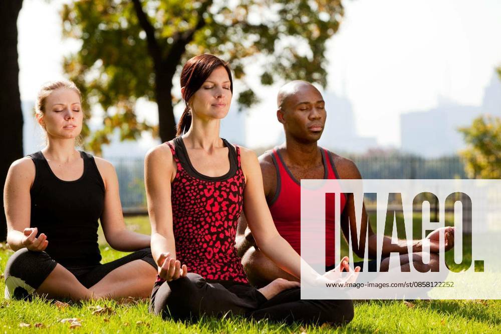 A group of people doing yoga in a city park model released Symbolfoto