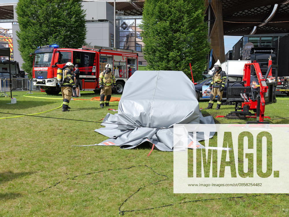 Interschutz 2026 in Hanover A burning electric car is covered with a fire blanket