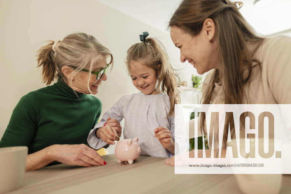Smiling mother and grandmother teach daughter saving money indoors model released, Symbolfoto property released, JCCMF15274