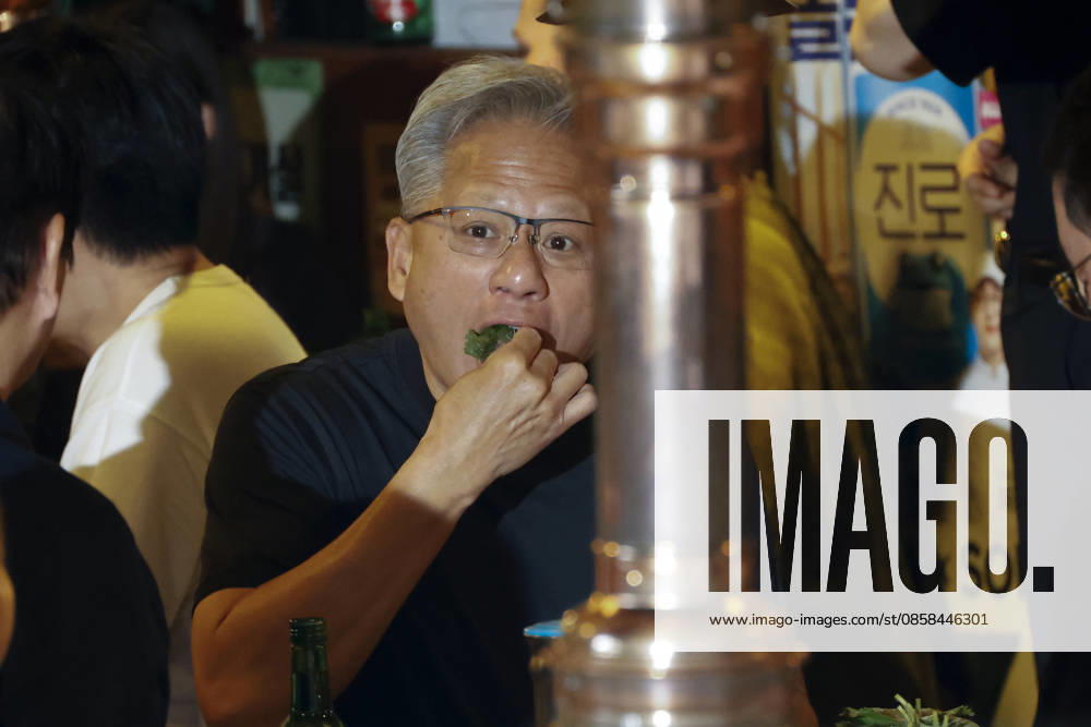 Nvidia CEO jensen huang poses with Naver, LG and SK chiefs after dinner in Seoul Jensen Huang, chief executive officer of Nvidia, eats a traditional lettuce wrap during dinner at a Korean BBQ restaurant in Seoul, South Korea, on June 05, 2026. Seoul South Korea