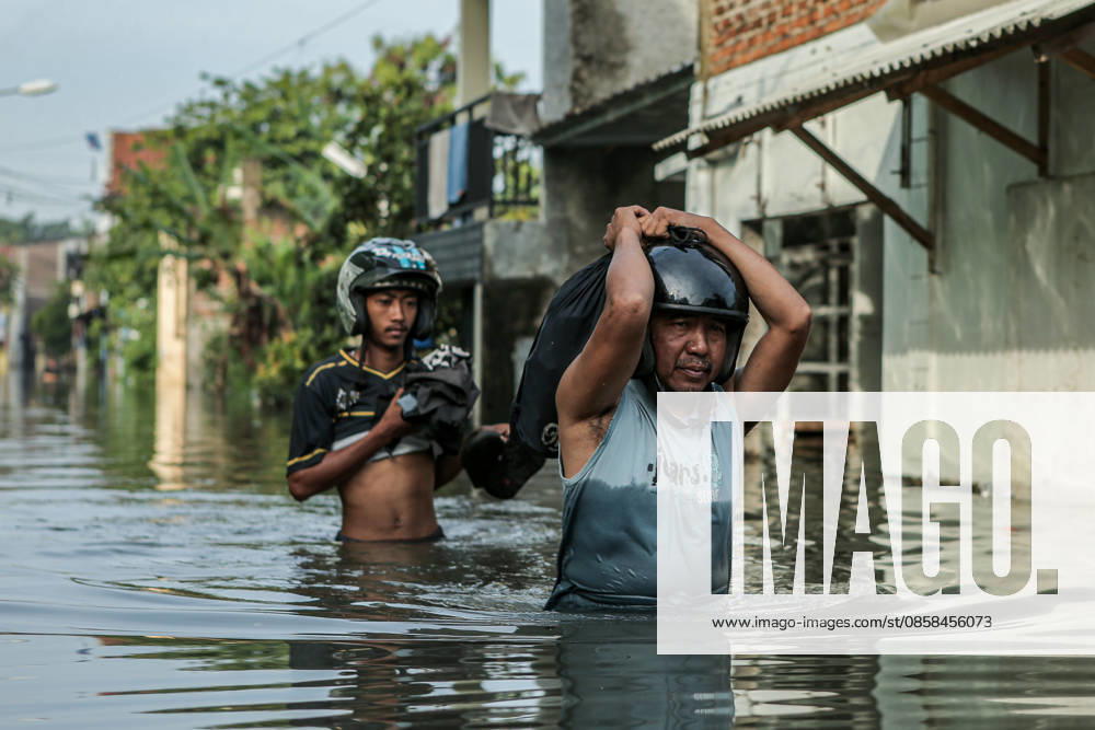 People wade through floodwaters. Flooding that began on May 24, 2026, caused by the overflowing of the Citarum River following heavy rains, has affected several areas in the regency, including Dayeuhkolot and Bojongsoang, with water levels reaching 20 200 cm. Bandung Regency West Java Indonesia