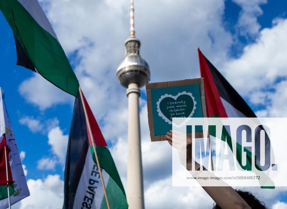 During a Naksa Day demonstration in Berlin, a protester holds a sign reading, â€oeI just want children to have a future.†Berlin s iconic Berliner Fernsehturm (TV Tower) can be seen in the background, while Palestinian flags surround the crowd. Berlin Germany - ZUMAc291 20260605_zip_c291_008