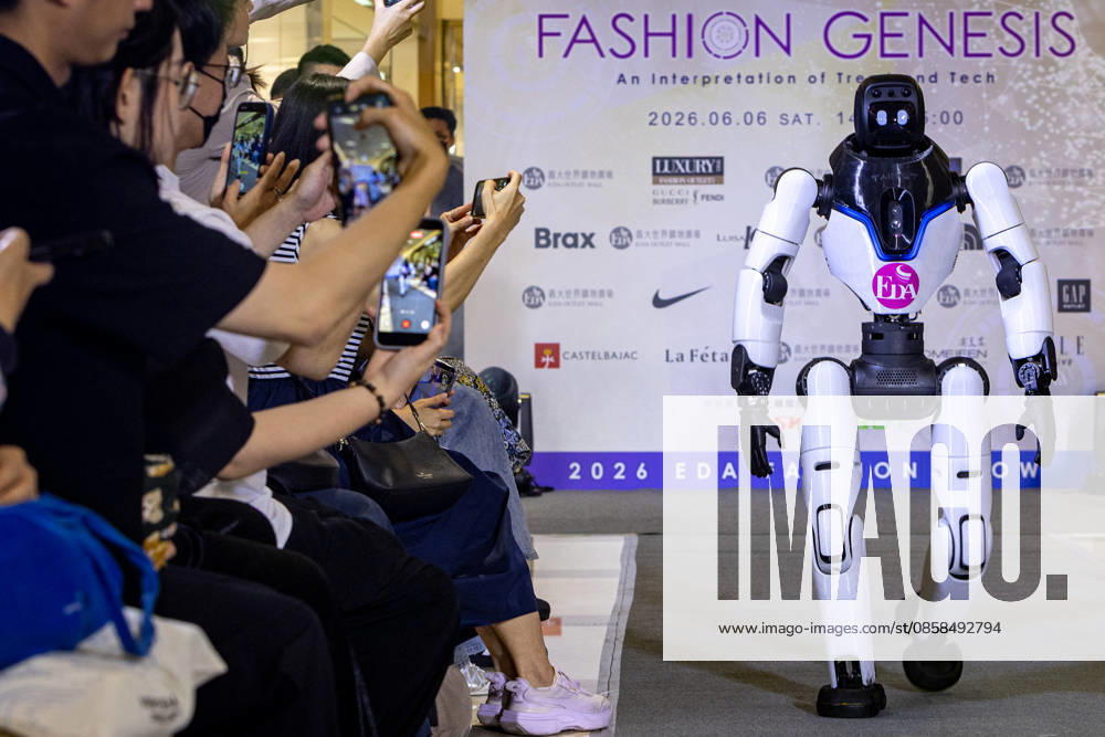 A bipedal humanoid robot walks down the runway at the 2026 EDA Fashion Show under the theme FASHION GENESIS, marking Taiwan s first-ever robotic fashion runway event, while attendees hold up smartphones to record the performance at E-DA Outlet Mall in Kaohsiung on June 6, 2026. Kaohsiung City Taiwan - ZUMAh198 20260606_zip_h198_001