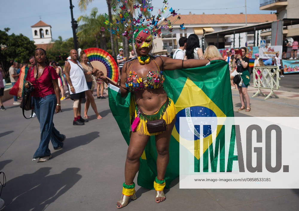A woman is seen holding a colorful fan as he poses for a photo with the brazilian flag during a demonstration in support of the rights of LGTBIQ+ people, as part of the LGTBIQ+ Pride celebrations. The LGTBIQ+ Pride of Torremolinos is internationally known as a meeting point for LGTBIQ+ people in a colourful and festive atmosphere, where thousands of people celebrate the fight of the LGTBIQ+ movement for equality and respect. Malaga Spain - ZUMAs197 20260606_aaa_s197_354
