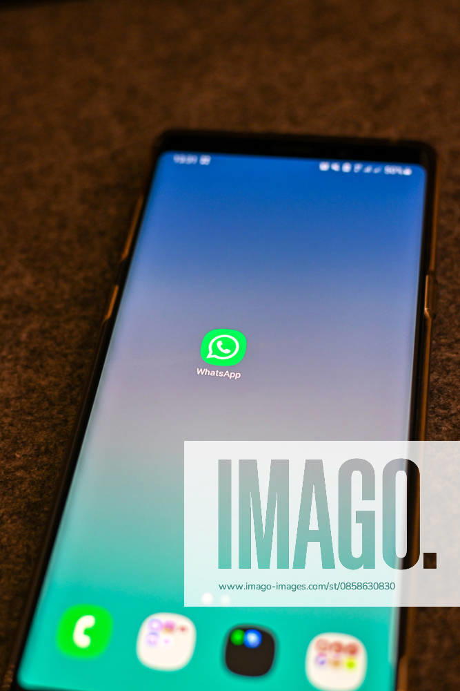 The logo of the messenger service WhatsApp on the display of a smartphone WhatsApp is one of the worlds most widely used communication services for messages, voice and video calls Bad Wörishofen Bavaria Germany