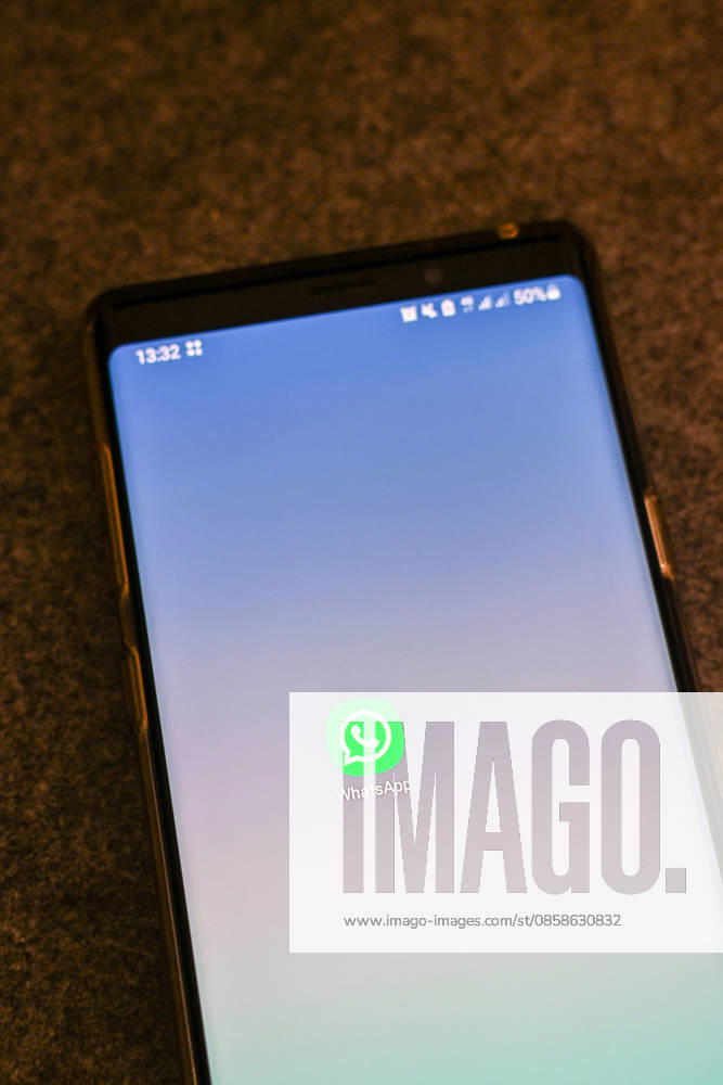 The logo of the messenger service WhatsApp on the display of a smartphone WhatsApp is one of the worlds most widely used communication services for messages, voice and video calls Bad Wörishofen Bavaria Germany
