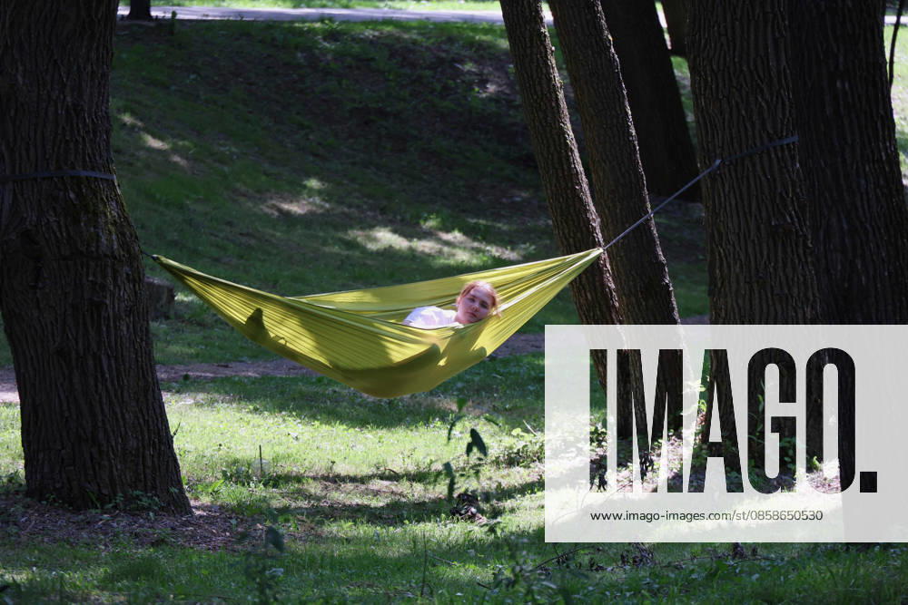 Summer in Kharkivs Sarzhyn Yar Park A girl relaxes in a hammock strung between two trees in Sarzhyn Yar Park on Sunday, Kharkiv, Ukraine, June 7, 2026. Despite the citys proximity to the frontline and the constant threat of Russian attacks, locals and visitors spend summer weekends in Sarzhyn Yar Park, one of Kharkivs most popular places., Credit:Biacheslav Madiievskyi Ukrinform Avalon Ukraine, Kharkiv