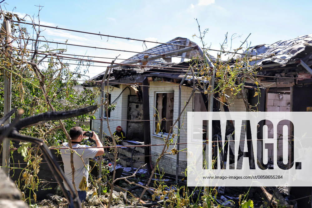 A man takes a picture of a house, damaged by a Russian drone attack, Oleksandrivka village, Odesa region, Ukraine, June 8, 2026. (Photo by Nina Liashonok Ukrinform) Russian troops attack Odesa and region with drones