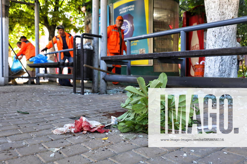 A blood-soaked wipe and a chestnut branch lie on the ground at a public transport stop as municipal workers sweep away glass shards after a Russian drone attack, Odesa, Ukraine, June 8, 2026. Russian forces attacked the southern Ukrainian city with Shahed-type drones. The wreckage of a downed drone fell directly onto a public transport stop, damaging the stop itself, as well as a control room, and several shared taxis. Three people were injured. (Photo by Nina Liashonok Ukrinform) Russian troops attack Odesa and region with drones