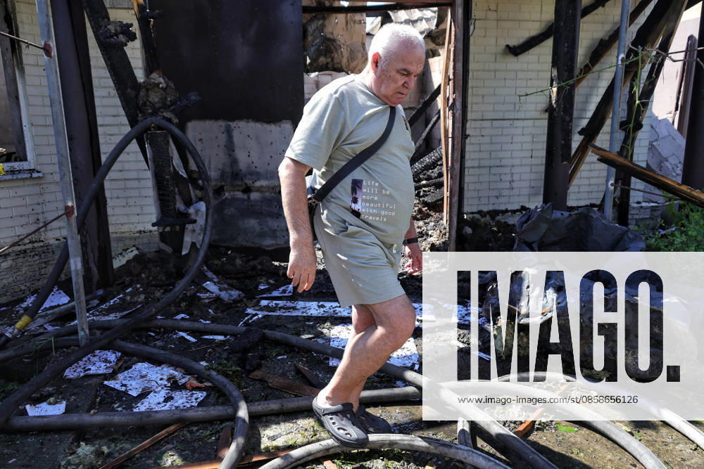 An elderly man steps over fire hoses outside a house damaged by a Russian drone attack, Oleksandrivka village, Odesa region, Ukraine, June 8, 2026. (Photo by Nina Liashonok Ukrinform) Russian troops attack Odesa and region with drones