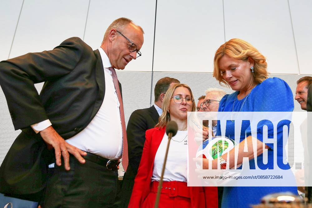 German Bundestag Union parliamentary group meeting Bundestag President Julia Klöckner CDU signs in front of party leader and Federal Chancellor Friedrich Merz CDU at World Cup Ball Trionda