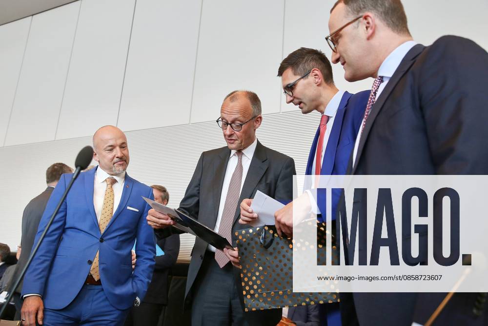German Bundestag Union parliamentary group meeting Federal Chancellor Friedrich Merz CDU receives a record from CDU MP Sepp Müller 2 v R, Alexander Müller L and Jens Spahn R look on