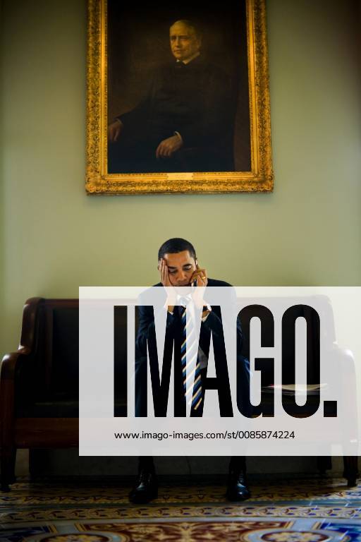 U.S. Senator and 2008 democratic Presidential candidate Barack Obama sits beneath a painted portrait of Arthur Pue Gorman, a Senator from Maryland at the end of the 19th century, and talks on a cell phone outside the Senate chamber in the U.S. Capitol, Friday, March 23, 2007., Washington D.C. USA