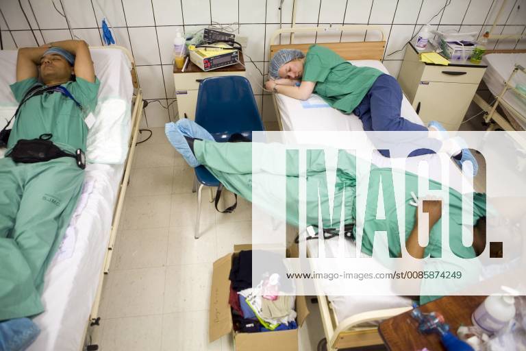 American doctors and nurses crash out in the post op ward after many long days of doing charity work at the Naval Hospital in Esmeraldas, Ecuador on February 14. (Photo by Dennis Drenner Aurora)., Esmeraldas Ecuador