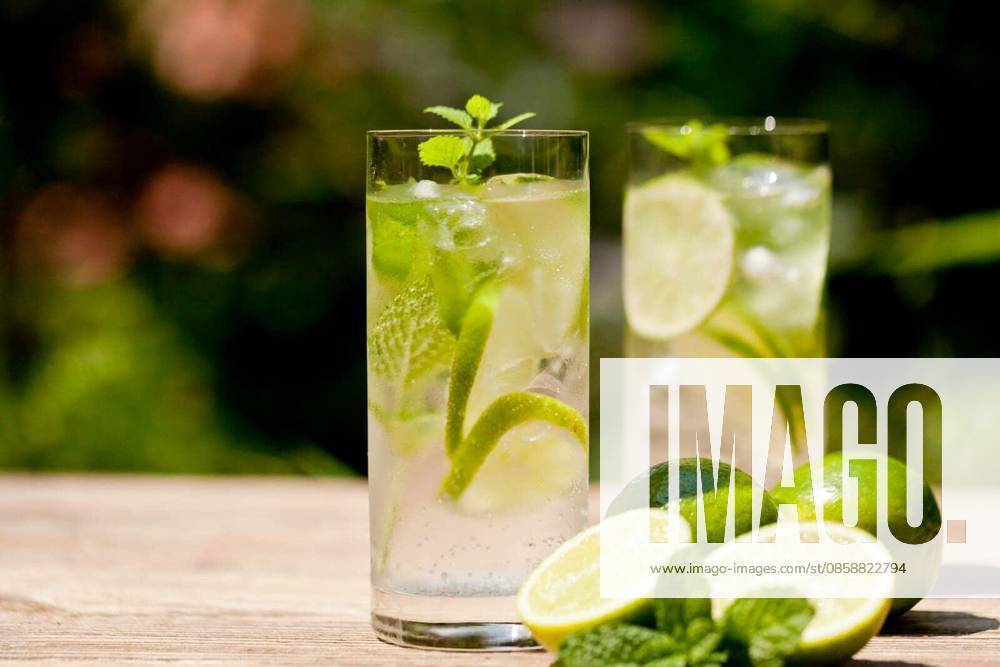 Healthy soft drink mineral water with limes and mint in summer