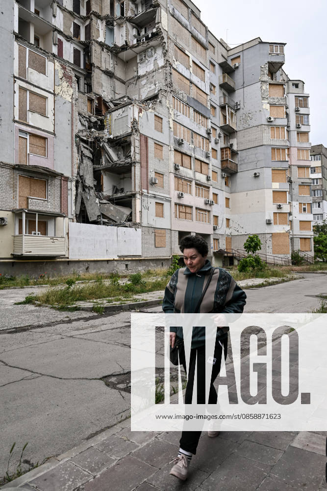 A woman walks past a residential building destroyed by a Russian guided aerial bomb strike is seen in the frontline city of Kherson, Ukraine, on June 3, 2026. The Russian army attacks the city daily with FPV drones and other unmanned aerial vehicles, deliberately terrorizing civilians. Russian forces conduct hunts for local residents, tracking them with FPV drones and dropping explosives. Police officers, medics, public transport, and urban infrastructure are also targeted. Based on the intensity of attacks, Kherson is informally divided into yellow and red zones, with the red zone considered the most dangerous due to constant shelling and drone strikes (Photo by Dmytro Smolienko Ukrinform) Life under shelling in frontline Kherson