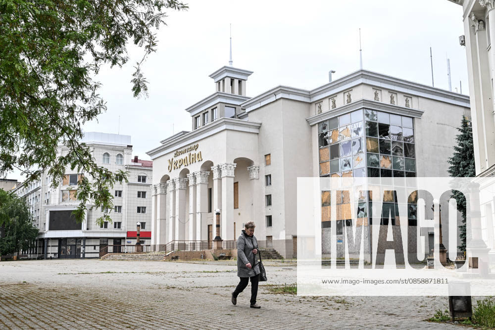 A woman walks past the damaged Ukraina cinema in the red zone of the frontline city of Kherson, the area considered the most dangerous due to constant Russian attacks, Kherson, Ukraine, on June 3, 2026. The Russian army attacks the city daily with FPV drones and other unmanned aerial vehicles, deliberately terrorizing civilians. Russian forces conduct hunts for local residents, tracking them with FPV drones and dropping explosives. Police officers, medics, public transport, and urban infrastructure are also targeted. Based on the intensity of attacks, Kherson is informally divided into yellow and red zones, with the red zone subjected to continuous shelling and drone strikes. Anti-drone netting has been installed above roads to he