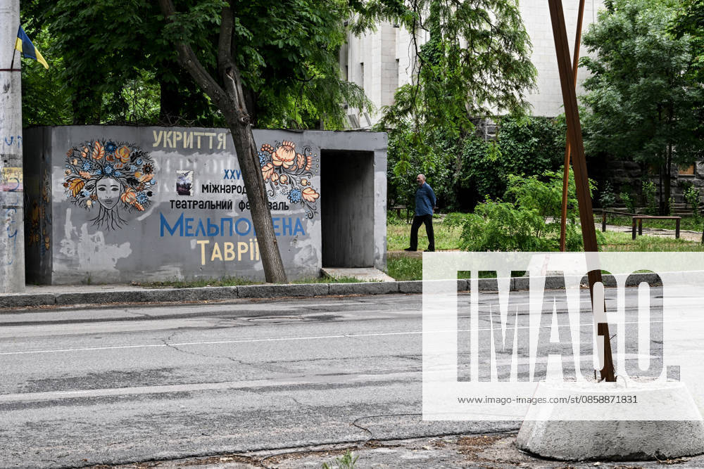 A resident of frontline Kherson walks past a mobile concrete shelter in the city’s red zone, the area considered the most dangerous due to constant Russian attacks, Kherson, Ukraine, on June 3, 2026. The Russian army attacks the city daily with FPV drones and other unmanned aerial vehicles, deliberately terrorizing civilians. Russian forces conduct hunts for local residents, tracking them with FPV drones and dropping explosives. Police officers, medics, public transport, and urban infrastructure are also targeted. Based on the intensity of attacks, Kherson is informally divided into yellow and red zones, with the red zone subjected to continuous shelling and drone strikes. Anti-drone netting has been installed above roads to help