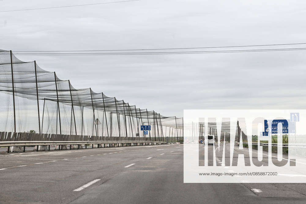 An anti-drone tunnel installed above the Mykolaiv–Kherson highway to protect against Russian FPV drones is seen in Kherson region, Ukraine, on June 3, 2026. The Russian army attacks the city daily with FPV drones and other unmanned aerial vehicles, deliberately terrorizing civilians. Russian forces conduct hunts for local residents, tracking them with FPV drones and dropping explosives. Police officers, medics, public transport, and urban infrastructure are also targeted (Photo by Dmytro Smolienko Ukrinform) Life under shelling in frontline Kherson