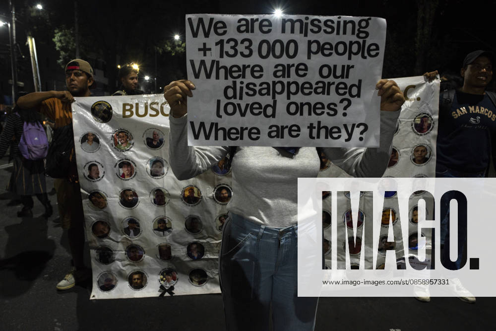 Mexico City Missing Persons March A demonstrator holds a sign reading We are missing +133 000 people in front of a banner showing missing persons during a march in Mexico City, Mexico, on June 10, 2026. The march, heading toward Estadio Azteca as part of the Let s illuminate the search event, brought together families from various Mexican states calling for justice for their missing relatives. Mexico City Mexico City Mexico