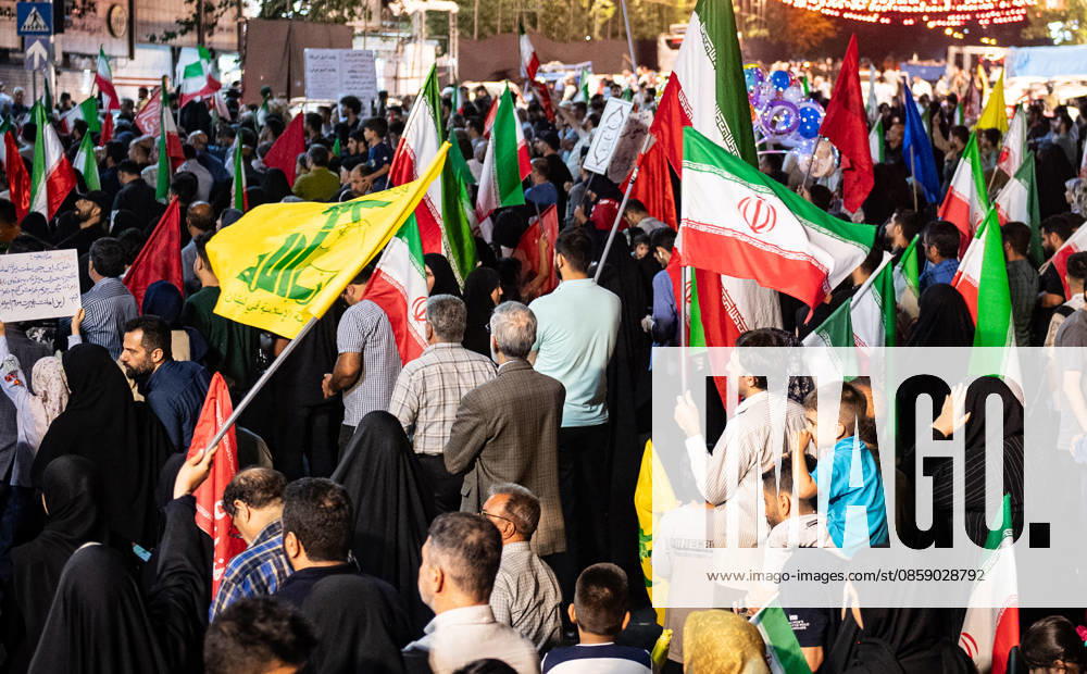 Iranians carries and National flag and Hezbollah, the Lebanese group, is a key ally of Iran flag during a rally , as crowds wave flags in support of the government s negotiations to end the war with the United States. Anti?U.S. and anti?Israel chants echoed through Enghelab Square in Tehran late Friday, June 12, 2026. IRN2026061221 BehnamxTofighi