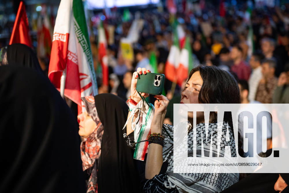 An Iranian woman wearing a keffiyeh attends a rally in support of the Iranian government s negotiations to end the war with the United States at Enghelab Square in Tehran, Iran on Friday, June 12, 2026. IRN2026061228 BehnamxTofighi