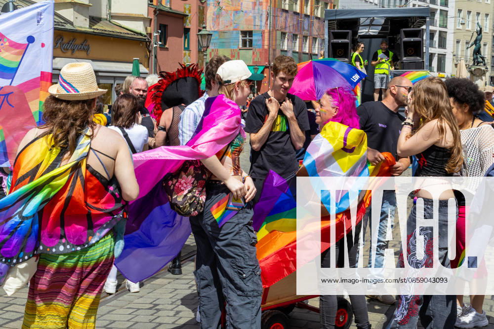 Augsburg, Bavaria, Germany June 13, 2026: Participants carrying rainbow flags and wearing colorful costumes take part in Christopher Street Day (CSD) in Augsburg. The parade through the city center promotes the rights of LGBTQ+ people as well as social diversity and tolerance. Several participants carry various Pride and identity flags