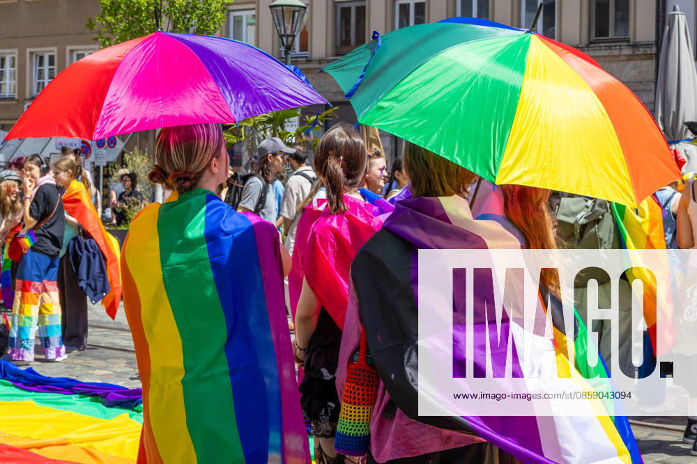 Augsburg, Bavaria, Germany June 13, 2026: Participants carrying rainbow flags and wearing colorful costumes take part in Christopher Street Day (CSD) in Augsburg. The parade through the city center promotes the rights of LGBTQ+ people as well as social diversity and tolerance. Several participants carry various Pride and identity flags