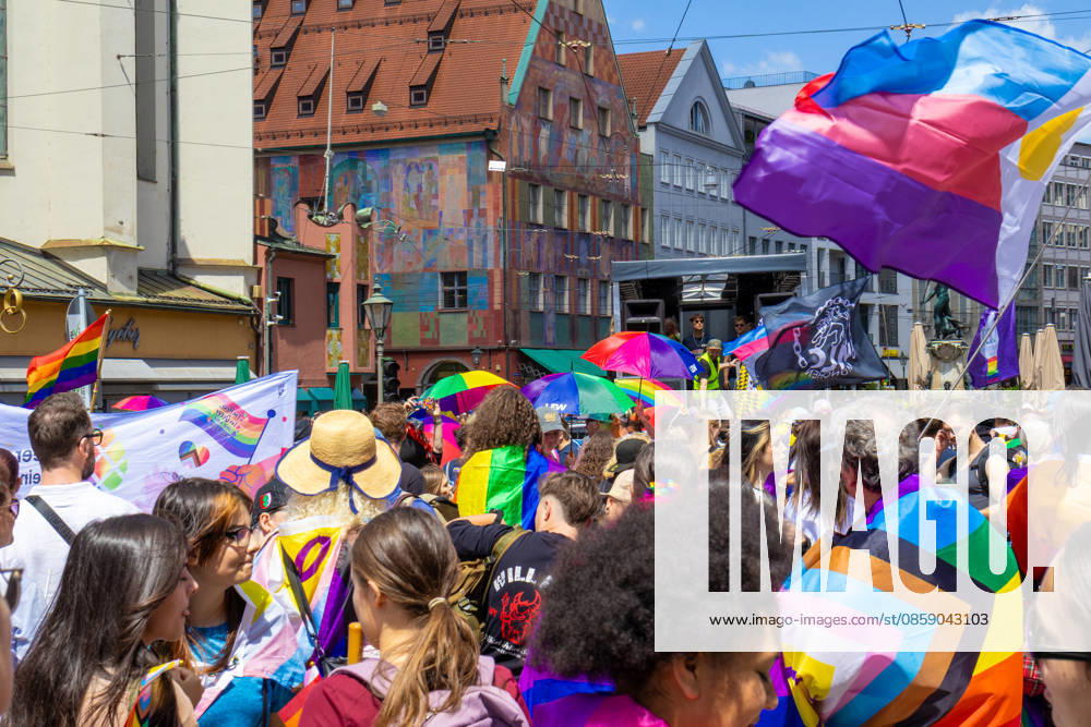 Augsburg, Bavaria, Germany June 13, 2026: Participants carrying rainbow flags and wearing colorful costumes take part in Christopher Street Day (CSD) in Augsburg. The parade through the city center promotes the rights of LGBTQ+ people as well as social diversity and tolerance. Several participants carry various Pride and identity flags