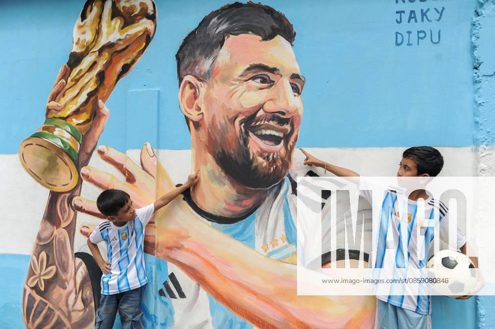 Sylhet, Bangladesh- Children wearing Argentina football jerseys gesture toward a mural of Argentine football player Lionel Messi in Sylhet, Bangladesh, on June 14, 2026. Football supporters in Bangladesh closely follow major international teams and players. - ZUMAr143 20260614_zap_r143_002