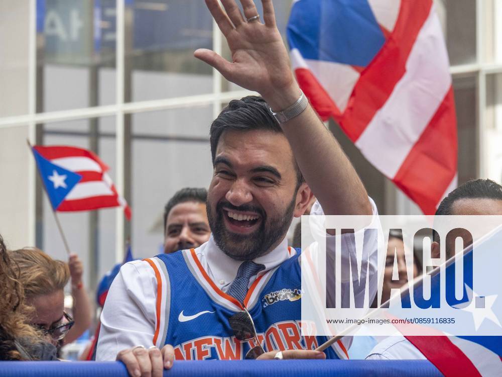 NYC Mayor Zohran Mamdani marching (wearing a NY Knicks Jersey) in the 69th annual Puerto Rican Day Parade which made its way up Fifth Avenue to a sea of red white and blue celebrating the expansive cultural legacy and global footprint of .Puerto Rico. Salsa music, floats, dance and Puerto Rican pride filled the air as thousands marched and.watched from the sidelines. New York USA - ZUMAh156 20260614_znp_h156_001