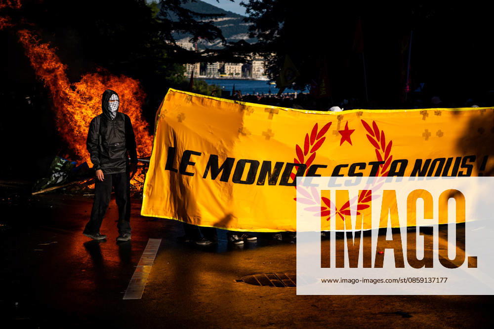 #2 Demonstration against the G7 summit in Geneva on June 14, 2026 Nicolas Liponne MAXPPP Geneve 14 06 2026 Black Bloc protesters hold a banner reading The world is ours in front of a burning barricade during clashes with police at the international demonstration against fascism, capitalism and imperialism, part of the mobilization against the G7 summit, qui aura lieu à Évian du 15 au 17 juin, à Genève le 14 juin 2026 Black Bloc protesters hold a banner reading The world is ours in front of a burning barricade during clashes with police at the international demonstration against fascism, capitalism, and imperialism, as part of the mobilization for the G7 counter summit, which will take place in Évian from June 15 to 17, in Geneva on June 14, 2