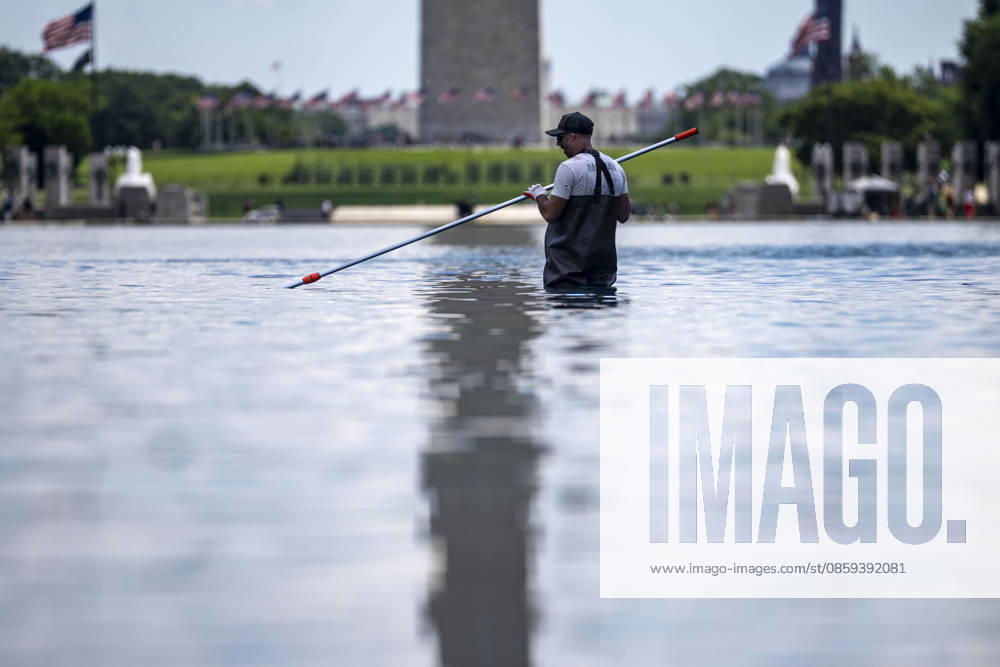 A U.S. National Park Service employee uses a vacuum pump to clean algae off the bottom of the newly repainted Lincoln Memorial Reflecting Pool on the National Mall in Washington, DC on Wednesday, June 17, 2026. The Trump Administration spent $16 million to paint the bottom of the pool American flag blue and as part of an effort to repair Washington landmarks in for preparation the country s 250th birthday this summer. WAP20260617302 BONNIExCASH