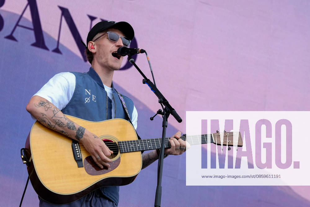 Scottish singer songwriter Nathan Evans born Nathan Alexander Evans, performing live on stage with The Saint PHNX Band at the Isle of Wight festival. He first gained fame in 2020 by posting videos of himself singing sea shanties on TikTok. In 2021, he released a version of the folk song Wellerman which peaked at the top of the UK Singles Chart. The Saint PHNX Band is currently Nathan Evans Lead vocals and acoustic guitar., Stevie Jukes Lead vocals, guitar, and bass, Alan Jukes Backing vocals, drums, and percussion Newport United Kingdom - ZUMAs197 20260620_aaa_s197_145