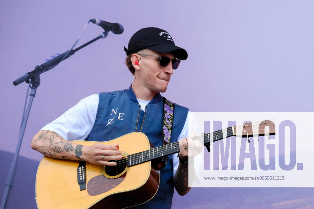 Scottish singer songwriter Nathan Evans born Nathan Alexander Evans, performing live on stage with The Saint PHNX Band at the Isle of Wight festival. He first gained fame in 2020 by posting videos of himself singing sea shanties on TikTok. In 2021, he released a version of the folk song Wellerman which peaked at the top of the UK Singles Chart. The Saint PHNX Band is currently Nathan Evans Lead vocals and acoustic guitar., Stevie Jukes Lead vocals, guitar, and bass, Alan Jukes Backing vocals, drums, and percussion Newport United Kingdom - ZUMAs197 20260620_aaa_s197_155