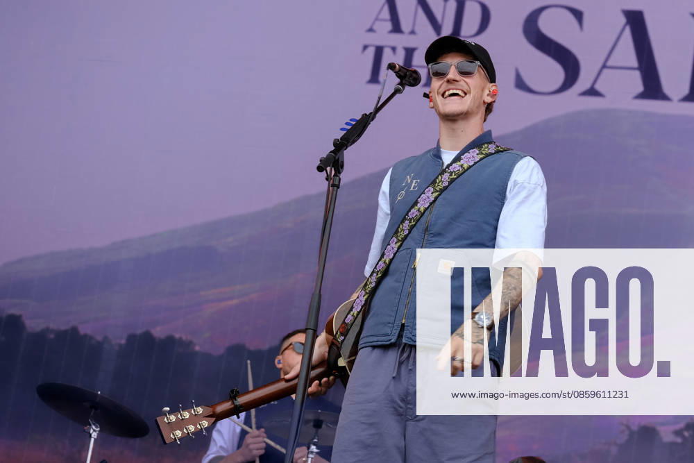 Scottish singer songwriter Nathan Evans born Nathan Alexander Evans, performing live on stage with The Saint PHNX Band at the Isle of Wight festival. He first gained fame in 2020 by posting videos of himself singing sea shanties on TikTok. In 2021, he released a version of the folk song Wellerman which peaked at the top of the UK Singles Chart. The Saint PHNX Band is currently Nathan Evans Lead vocals and acoustic guitar., Stevie Jukes Lead vocals, guitar, and bass, Alan Jukes Backing vocals, drums, and percussion Newport United Kingdom - ZUMAs197 20260620_aaa_s197_157