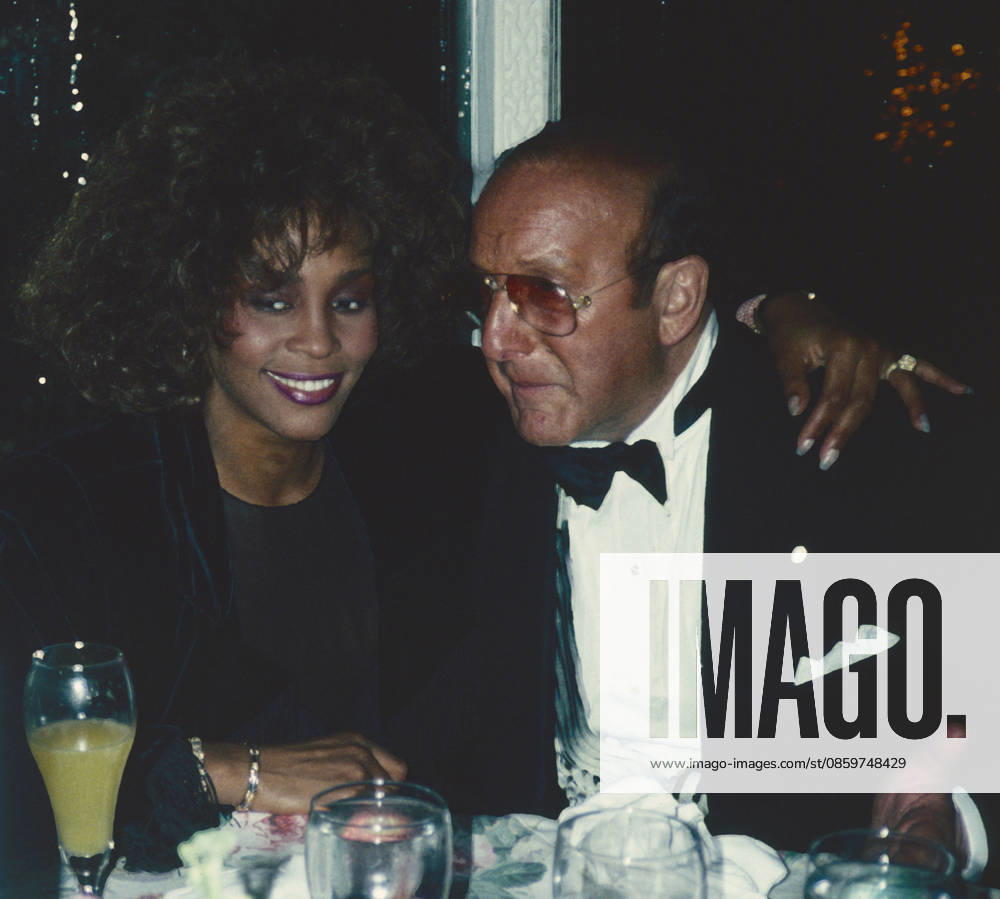 Whitney Houston and Clive Davis attend Arista AIDS Party at Tavern on the Green in New York City on March 17, 1990. Photo