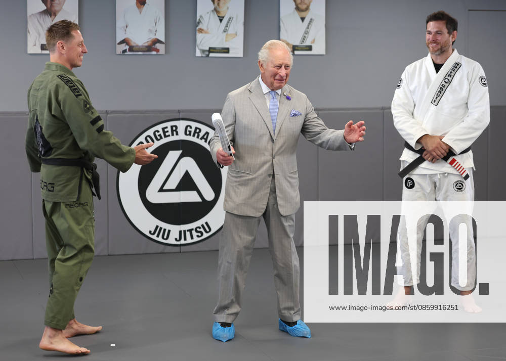 The King Hears How The Charity Reorg Uses Jiu Jitsu To Support Those Facing Physical, Mental And Social Challenges LONDON, ENGLAND - JUNE 24: King Charles III smiles as he receives a white belt from Roger Gracie (R) with founder of REORG Charity Sam Sheriff (L) during a visit to charity REORG at the Roger Gracie Brazilian Jiu Jitsu Academy on June 24, 2026 in London, England. REORG supports military personnel, veterans and emergency service workers through Brazilian Jiu Jitsu training in safe and supportive environments., Credit:Chris Jackson PA ROTA - B68 Avalon United Kingdom, England, London