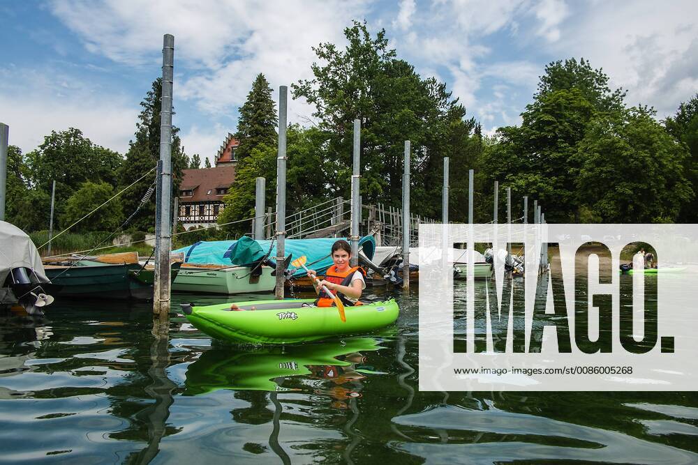 Lilli with her kayak on the Rhine in the port of Gaienhofen Lake Constance Baden Württemberg Germany Kayaking on the Upper Rhine on Lake Constance