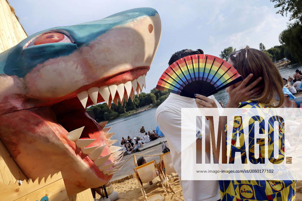 Visitors behind a rainbow fan next to a shark in the Sharkroom at the Rainbow Festival 2026 at Fühlinger See. Markus Krampe’s Rainbow Festival takes place as part of ColognePride. Cologne, June 27, 2026, North Rhine-Westphalia, Germany