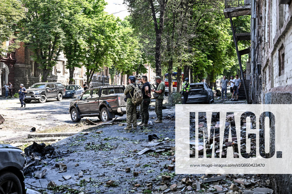 A law enforcer and EOD experts stand in the street, covered with rubble, outside buildings damaged by a Russian drone strike, Zaporizhzhia, Ukraine, June 30, 2026. On Tuesday, June 30, a Russian drone struck Zaporizhzhia, hitting the historic part of the city and damaging cultural heritage sites of local importance. The blast wave damaged cars, the Leshchynskyi House, the Zaporizhzhia Choral Synagogue (Leshchynskyi Synagogue), and the Pashutin family house. (Photo by Dmytro Smolienko Ukrinform) Russian attack historical centre of Zaporizhzhia with drone